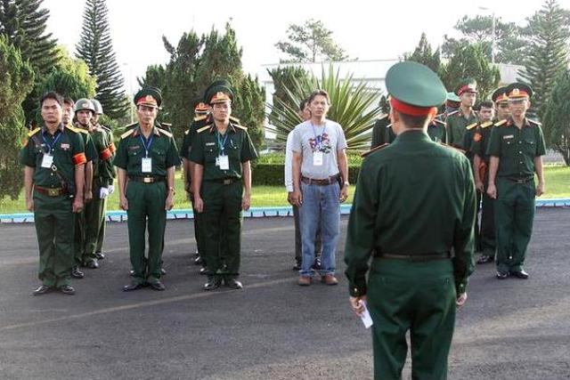 Vietnamese soldiers receive instructions prior to departing in a convoy carrying highly enriched uranium.